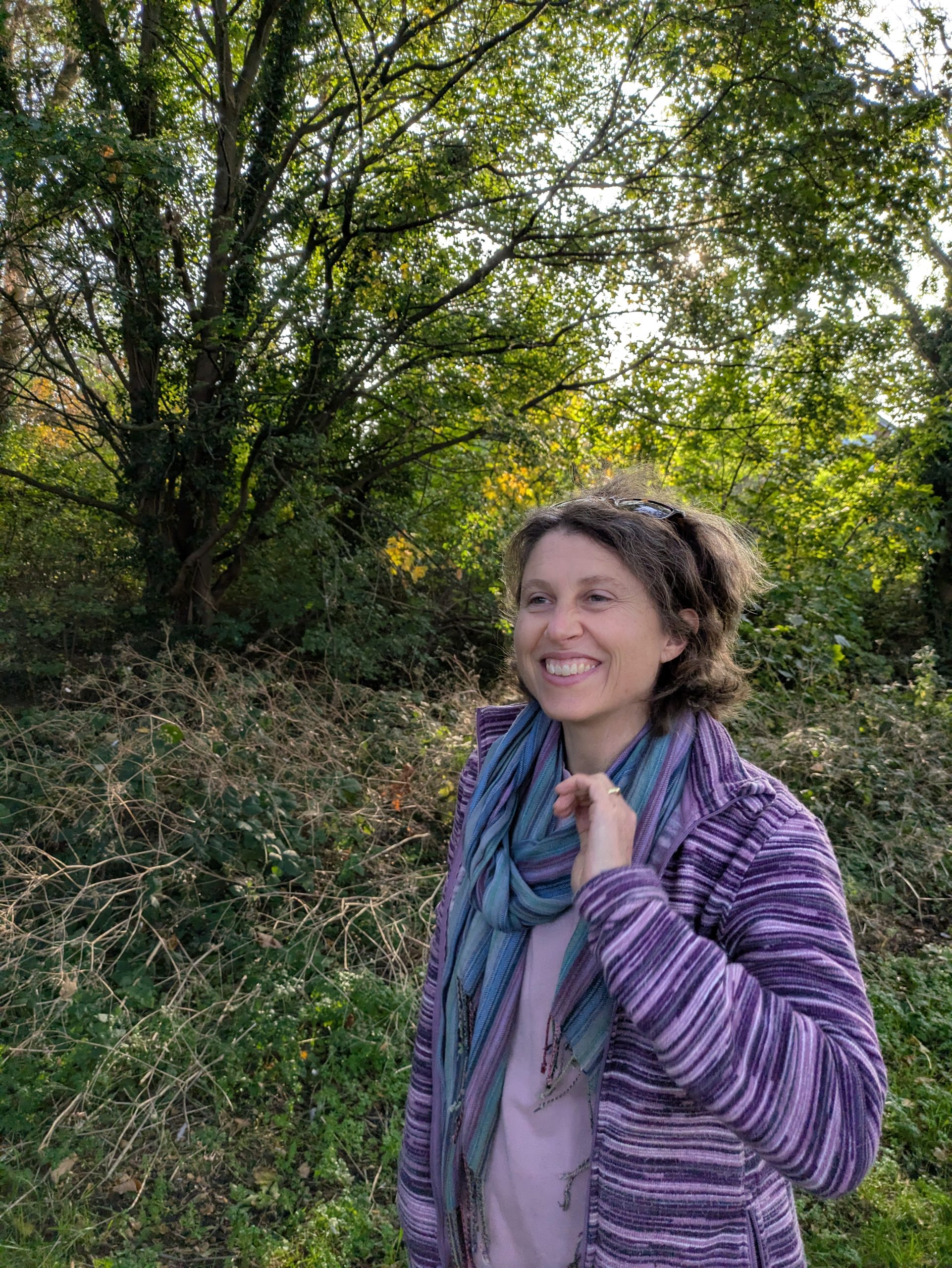 Image is a photo of Bec Foster outside in a wooded area.